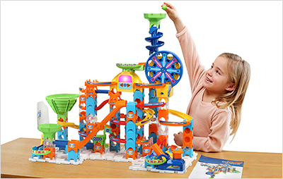 Child dropping marble down the funnel on Marble Rush Ultimate Set.